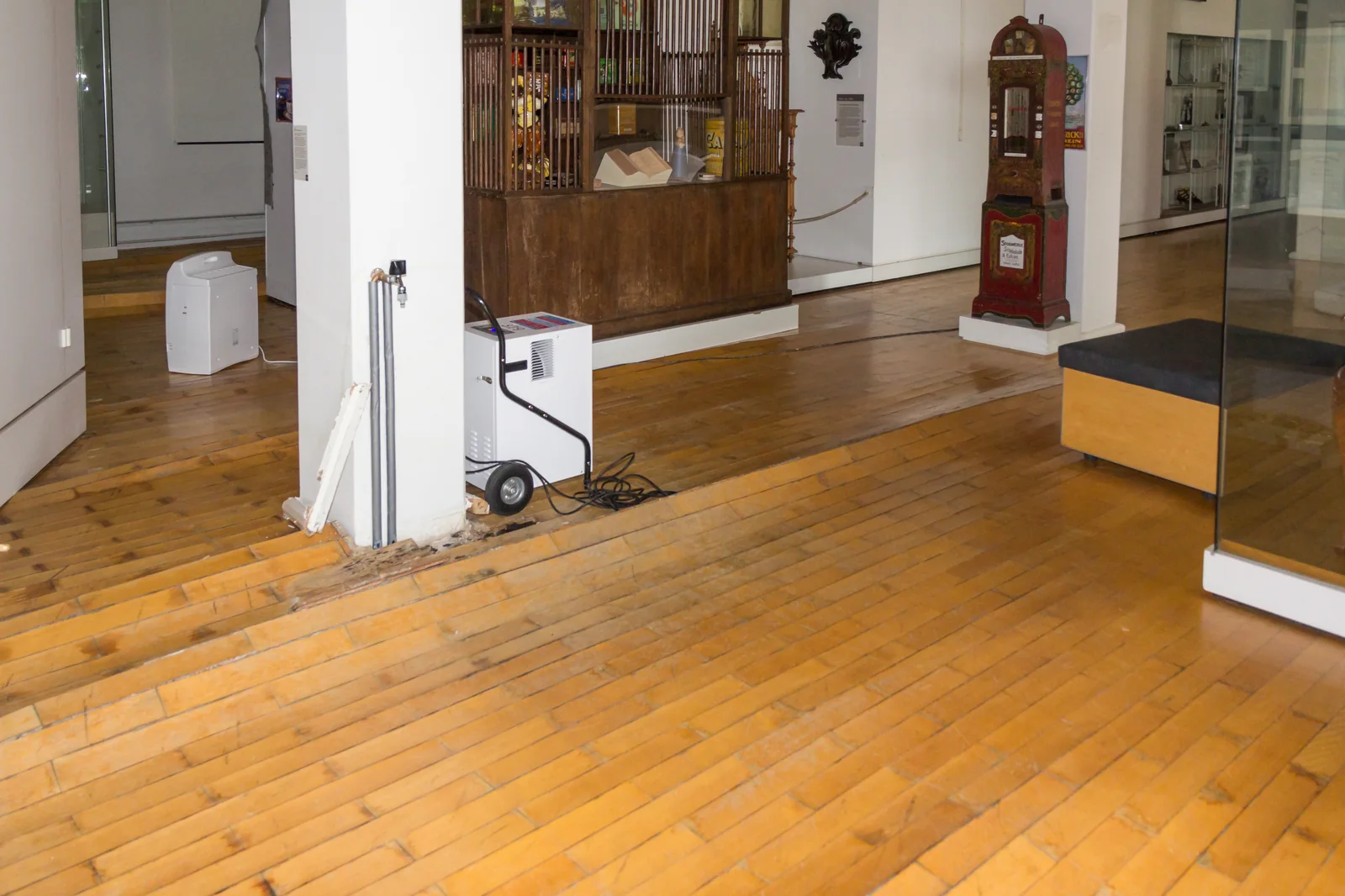 Dehumidifier drying a water-damaged floor after flooding, part of professional wet carpet drying in a Lancaster, CA home